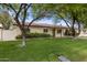 Exterior of charming single-story home featuring a well-manicured lawn and a welcoming green front door at 7608 E Avalon Dr, Scottsdale, AZ 85251