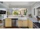 The kitchen features marble countertops, stainless steel appliances, trendy gold accents and a bright natural light at 7608 E Avalon Dr, Scottsdale, AZ 85251