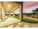 Covered patio with dining set and landscaped backyard with pool and fence, viewed from gravel-covered area at 7848 E Parkview Ln, Scottsdale, AZ 85255