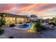 Resort-style backyard featuring a free-form pool, beautiful desert landscaping, and a covered patio, perfect for entertaining at 7848 E Parkview Ln, Scottsdale, AZ 85255