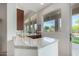 Entertaining area with a wet bar, granite countertop, wine rack, and a scenic view at 7848 E Parkview Ln, Scottsdale, AZ 85255