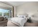 Cozy bedroom with tufted headboard, soft linens, neutral paint, and sliding glass door to the backyard at 7848 E Parkview Ln, Scottsdale, AZ 85255