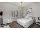 Bright bedroom with large window, white furnishings, neutral walls, and decorative zebra art at 7848 E Parkview Ln, Scottsdale, AZ 85255