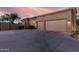 Exterior view of a home highlighting a three-car garage and desert landscaping for curb appeal at 7848 E Parkview Ln, Scottsdale, AZ 85255