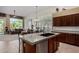 Spacious kitchen with island, breakfast bar, stainless steel appliances, and seamless flow into the living area at 7848 E Parkview Ln, Scottsdale, AZ 85255