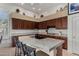 Kitchen features a center island with double sink, breakfast bar, and dark wood cabinets at 7848 E Parkview Ln, Scottsdale, AZ 85255