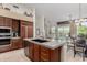 Gourmet kitchen features a center island with double sink, breakfast bar, and stainless steel appliances at 7848 E Parkview Ln, Scottsdale, AZ 85255