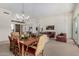 Open-concept living and dining area with chandelier, neutral paint, and multiple seating areas at 7848 E Parkview Ln, Scottsdale, AZ 85255