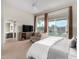 Spacious primary bedroom with sitting area, natural light, and serene backyard views at 7848 E Parkview Ln, Scottsdale, AZ 85255