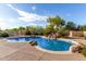 Beautiful pool with rock waterfall and landscaping, offering a tranquil backyard oasis at 7848 E Parkview Ln, Scottsdale, AZ 85255