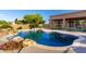 Inviting pool with rock features and lush landscaping, perfect for relaxation and outdoor enjoyment at 7848 E Parkview Ln, Scottsdale, AZ 85255