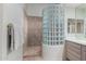 Modern shower with unique glass block wall, tiled walls, and neutral color palette at 7848 E Parkview Ln, Scottsdale, AZ 85255
