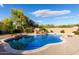A sparkling swimming pool with rock features and lush surroundings offers a private backyard retreat at 7848 E Parkview Ln, Scottsdale, AZ 85255