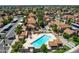 Aerial view of community pool with cabanas, lush landscaping, parking and houses at 7977 W Wacker Rd # 134, Peoria, AZ 85381