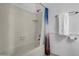 Bright bathroom featuring a white tub with a shower curtain and a tiled wall at 7977 W Wacker Rd # 134, Peoria, AZ 85381