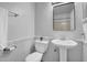 Cozy white bathroom featuring a pedestal sink, toilet, and a mirrored medicine cabinet at 7977 W Wacker Rd # 134, Peoria, AZ 85381