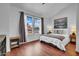 A bright bedroom with laminate wood floors, two windows, neutral décor, and a vaulted ceiling at 7977 W Wacker Rd # 134, Peoria, AZ 85381
