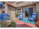 Private enclosed patio with brick pavers, a slider door, furniture, and desert landscaping at 7977 W Wacker Rd # 134, Peoria, AZ 85381