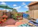 Enclosed patio features a colorful landscape area, gravel, patio furniture, and a blue fence at 7977 W Wacker Rd # 134, Peoria, AZ 85381