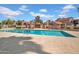 Community pool surrounded by desert landscaping and cabanas with shady spots for relaxation at 7977 W Wacker Rd # 134, Peoria, AZ 85381