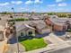 Aerial shot of a single-story home in a quiet suburban neighborhood with mountain views in the distance at 8531 E Natal Cir, Mesa, AZ 85209