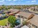 Backyard view of a single-story house with a pool, patio area, desert landscaping, and mature trees at 8531 E Natal Cir, Mesa, AZ 85209