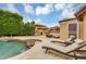 Outdoor living space showcasing a pool, fireplace, lounge seating, and desert landscaping at 8531 E Natal Cir, Mesa, AZ 85209