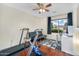 Bedroom features laminated floors, ceiling fan, and large window at 8531 E Natal Cir, Mesa, AZ 85209