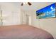 Neutral bedroom boasts laminated floors, ceiling fan, and walk-in closet at 8531 E Natal Cir, Mesa, AZ 85209