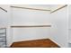 Spacious walk-in closet with built-in shelves and laminate floors at 8531 E Natal Cir, Mesa, AZ 85209