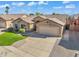 Inviting single-story house featuring a well-kept lawn, desert landscaping, and a spacious driveway at 8531 E Natal Cir, Mesa, AZ 85209