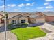 Charming single-story home with a well-manicured lawn, desert landscaping, and a two-car garage at 8531 E Natal Cir, Mesa, AZ 85209