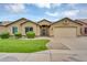 Charming single-story home featuring a manicured lawn, mature bushes, and a two-car garage at 8531 E Natal Cir, Mesa, AZ 85209