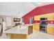 Kitchen featuring light wood cabinets, tile floors, stainless steel appliances, and a cozy eat-in area at 8531 E Natal Cir, Mesa, AZ 85209