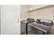 Laundry room features front-load washer, dryer, and storage shelf at 8531 E Natal Cir, Mesa, AZ 85209