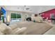Spacious living room with neutral tones, a ceiling fan, and sliding doors to the backyard pool at 8531 E Natal Cir, Mesa, AZ 85209
