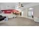 Open-concept living room with neutral tones, a ceiling fan, and adjoins the kitchen and dining area at 8531 E Natal Cir, Mesa, AZ 85209