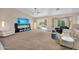 Spacious living room with neutral tones, a ceiling fan, and sliding doors to the backyard pool at 8531 E Natal Cir, Mesa, AZ 85209