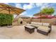Inviting patio featuring a fireplace, outdoor seating, and shade umbrellas, perfect for relaxation at 8531 E Natal Cir, Mesa, AZ 85209