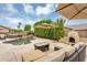 Gorgeous backyard oasis features a pool, spa, fireplace, lounge seating, and meticulous landscaping at 8531 E Natal Cir, Mesa, AZ 85209