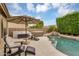 Relaxing backyard area features a pool with a waterfall, hot tub, and comfortable seating at 8531 E Natal Cir, Mesa, AZ 85209