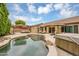 Backyard oasis features a pool, hot tub, lounge chairs, and mature landscaping at 8531 E Natal Cir, Mesa, AZ 85209