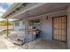 Covered back patio features an outdoor hot tub and secure door at 900 S Palo Verde Dr, Apache Junction, AZ 85120