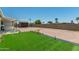 Backyard with green grass section, providing a pleasant outdoor space for recreation and relaxation at 900 S Palo Verde Dr, Apache Junction, AZ 85120