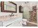 Stylish bathroom with a marble vanity, dark wood cabinetry, and a tiled shower with glass door at 900 S Palo Verde Dr, Apache Junction, AZ 85120