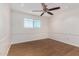 Comfortable bedroom featuring wood-look floors, white walls, and a ceiling fan at 900 S Palo Verde Dr, Apache Junction, AZ 85120