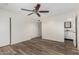 Large bedroom with wood-look floors, sliding door closet, and access to the bathroom at 900 S Palo Verde Dr, Apache Junction, AZ 85120