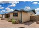 Image showcasing the side and rear exterior of a brick home, set in a desert landscape at 900 S Palo Verde Dr, Apache Junction, AZ 85120