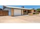 A single story home featuring a driveway and attached garage, and brick accents at 900 S Palo Verde Dr, Apache Junction, AZ 85120