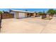 Single story home showing driveway, garage, brick accents and secure fencing at 900 S Palo Verde Dr, Apache Junction, AZ 85120